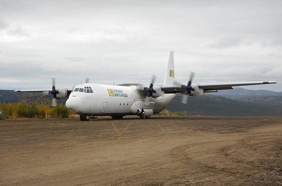 Hercules aircraft landing on dirt landing strip